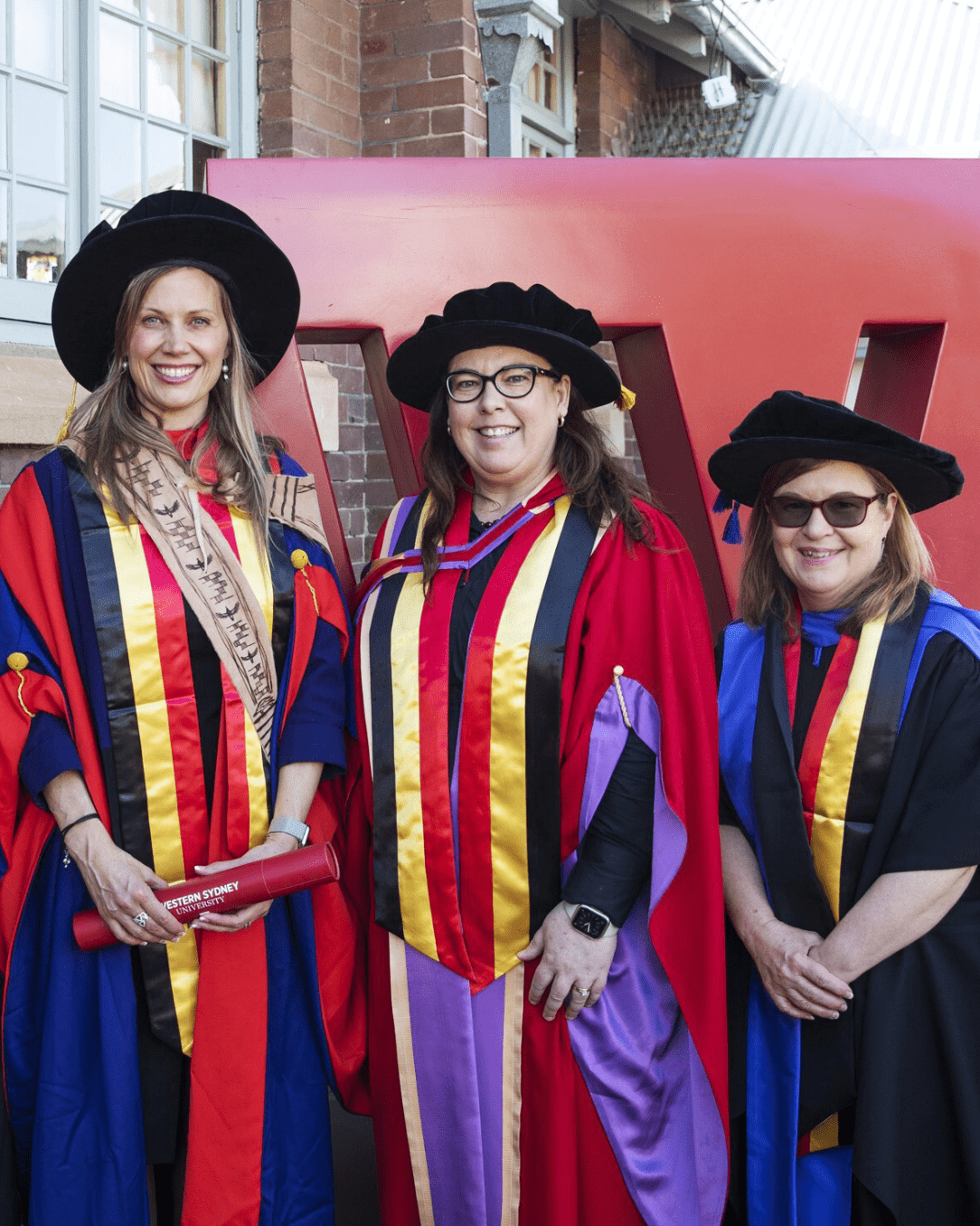 PhD supervisors Professor Michelle Trudgett and Professor Susan Page (middle and right) proudly attended Dr Stacey Kim Coates’ (left) graduation ceremony in November 2023. 