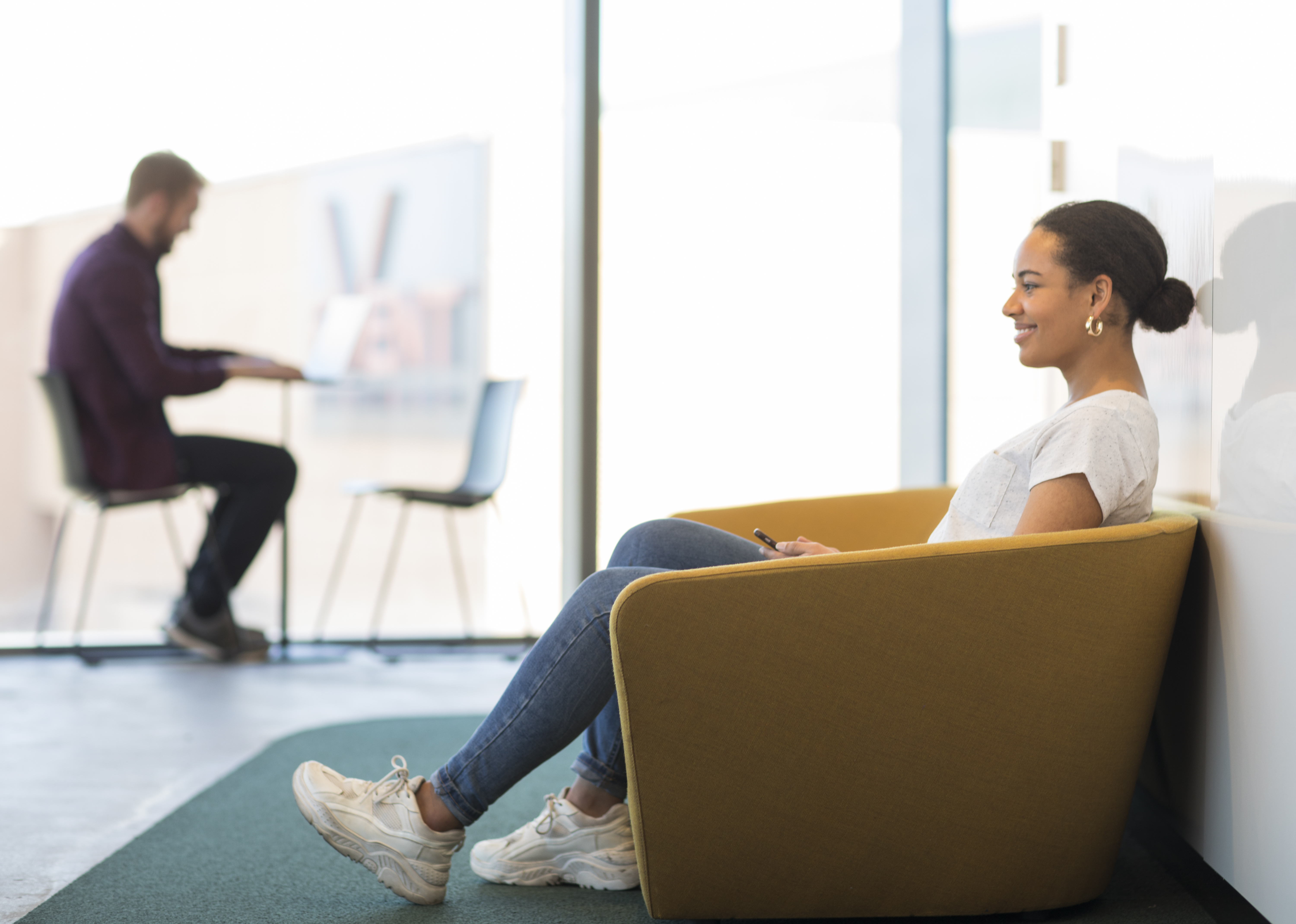 Two students sitting in a waiting area