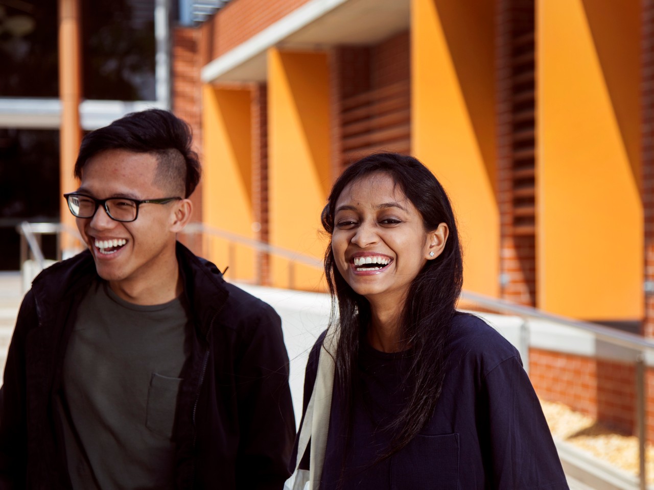 Two students standing facing the camera